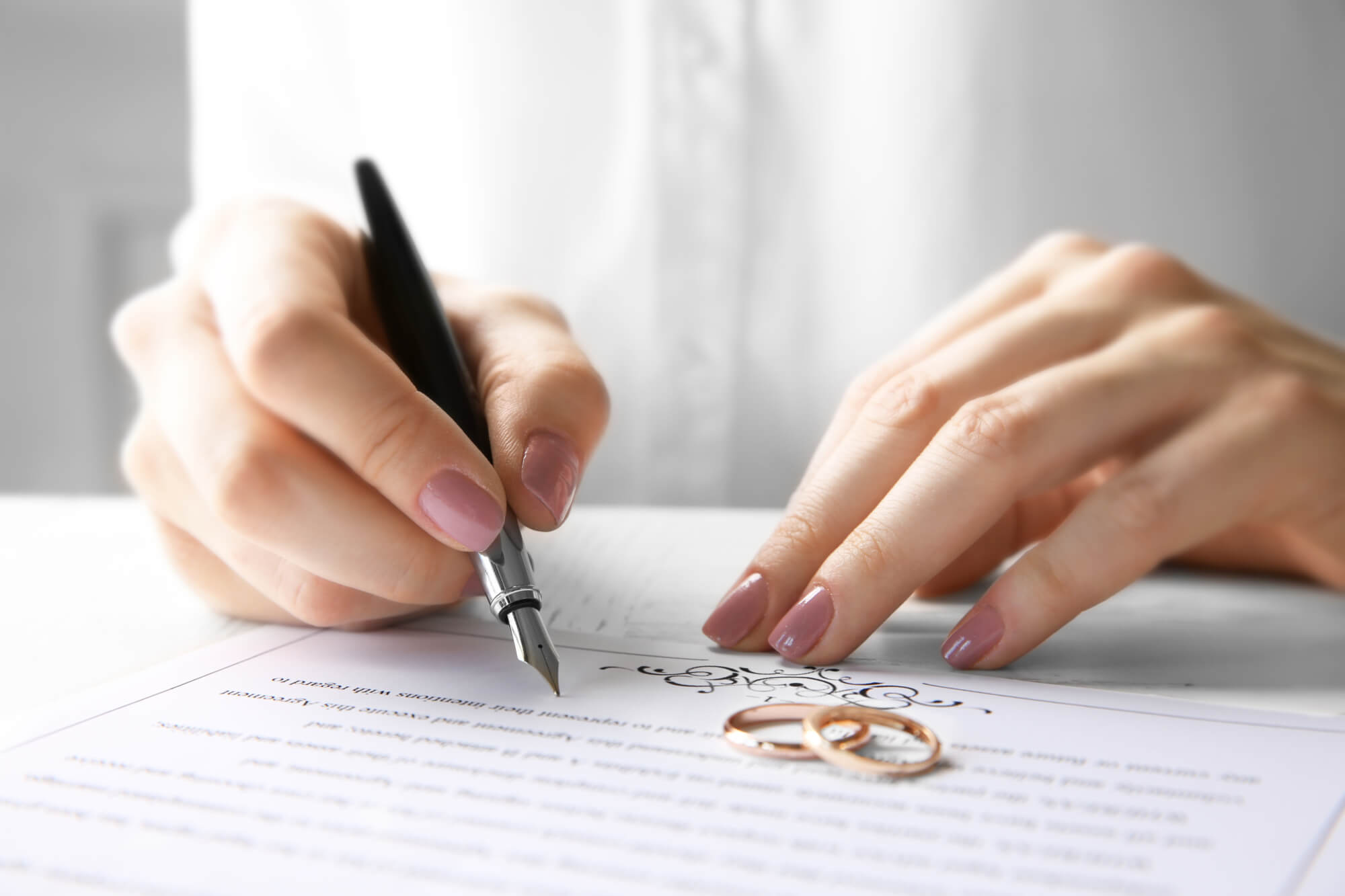 Woman signing wedding venue contract